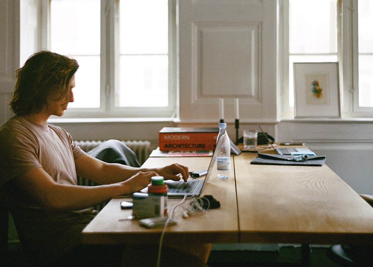 man-sitting-while-using-laptop-2825936